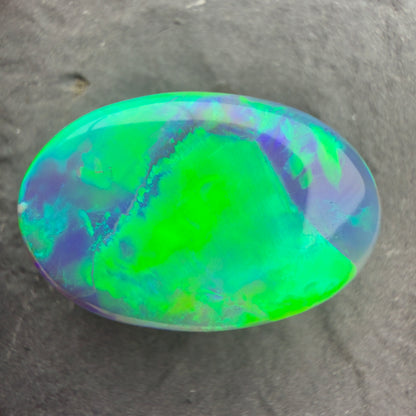 6.64ct World Class Black opal With Brilliant Green-Gold Color play And A Rolling Broad Flash Pattern