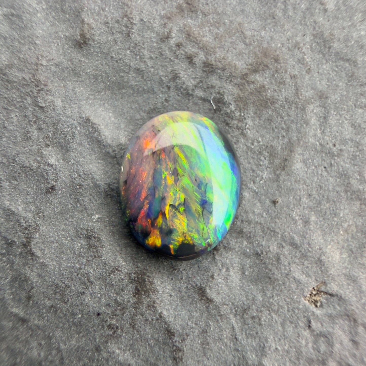 0.59cts Affordable Black Opal With A Vivid Red Pink Multicolor Play Of Color, From Lightning Ridge Australia