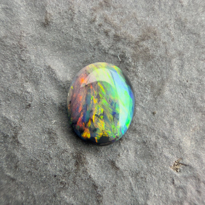 0.59cts Affordable Black Opal With A Vivid Red Pink Multicolor Play Of Color, From Lightning Ridge Australia