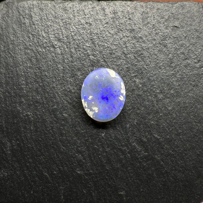 Mysterious Black Crystal Opal With A Central Blue-Green Pattern Fading To Violette At The Edges