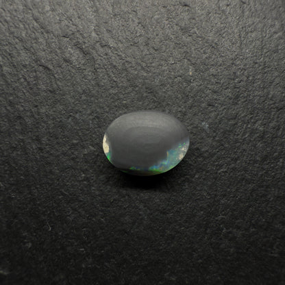 1.6ct Gem Black Opal With A Lovely Green-Gold Color palette With Hints OF Teal And A Mixed Patterns