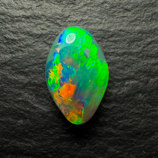 1.16ct Gem Black Opal, This Freeform Gem Has A Beautiful Array Of Orange Green and Gold with Hints Of Blue