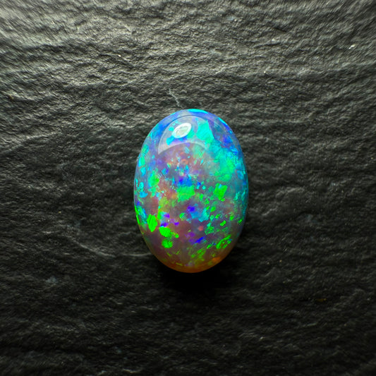 0.64ct Dark Crystal Opal With A Bright Blue Green Speckled Pinfire Like Pattern