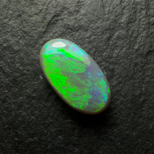 0.77ct Dark Opal, This Gem Has A Green-Gold Color Palette With A Textured Broadflash Pattern