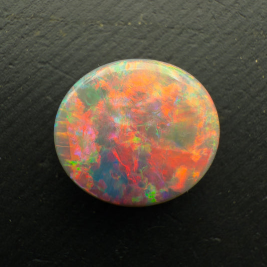 3.5ct Black Opal With A Rare Pink-Orange Broadflash Pattern, Shifting to Green As The Stone Is Moved