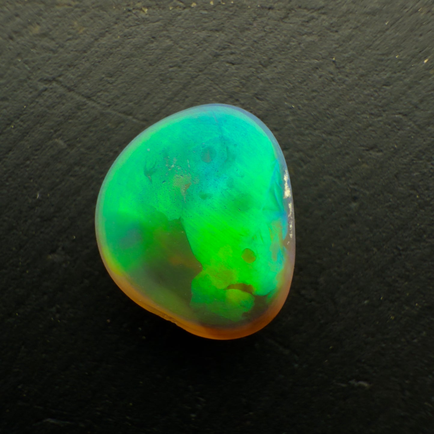 1.3ct Black Crystal Opal With A Brilliant Green Rolling Broadflash Pattern With Undertones Of Blue