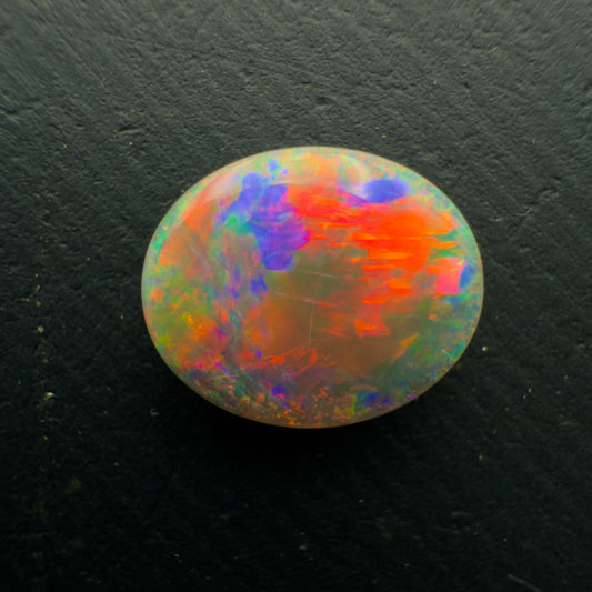 1.3ct Dark Crystal Opal With a Brilliant Red-Blue Color Palette And Full Faced Color