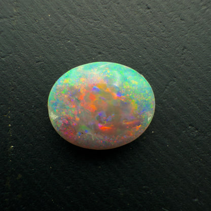 1.3ct Dark Crystal Opal With a Brilliant Red-Blue Color Palette And Full Faced Color