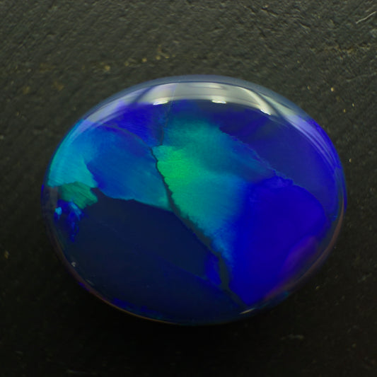 6.8ct Black Opal With A Flagstone Pattern And Color Fading From Aqua To Royal Blue