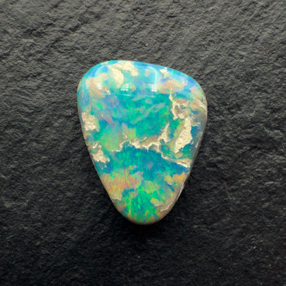 2.85ct Picture Stone Dark Opal With A Tropical Blue Green Color And Sandy colored Inclusions
