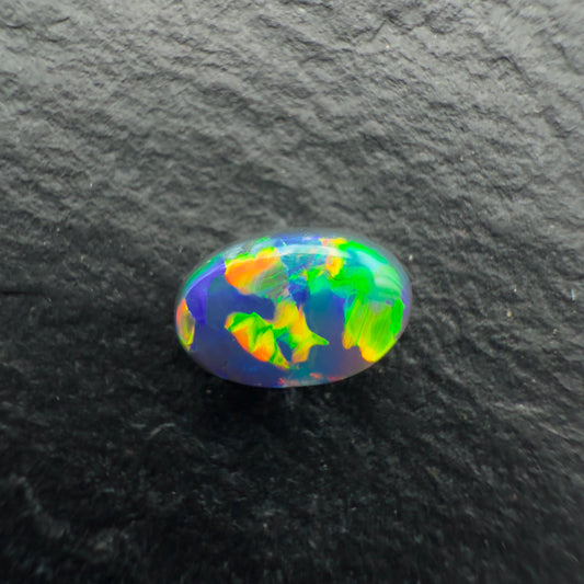 0.64ct World Class black opal With a Vivid Multicolor Palette and A Blocky Pattern