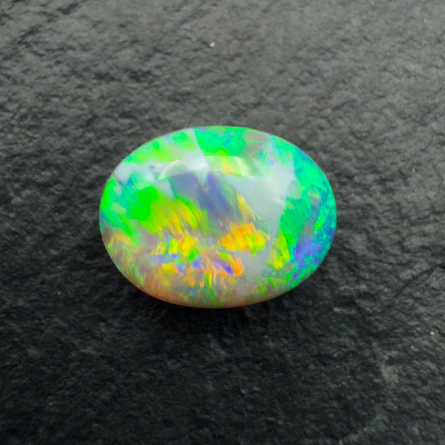 1.62ct Gem Dark Opal With Vivid Green-Gold Color Play And A Unique Striated Pattern
