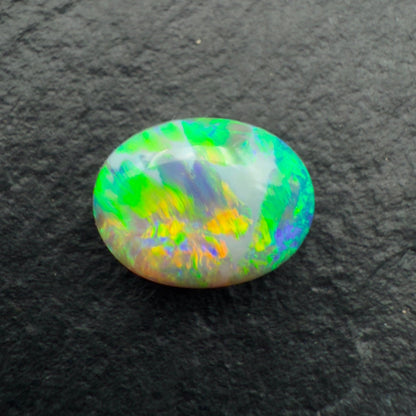 1.62ct Gem Dark Opal With Vivid Green-Gold Color Play And A Unique Striated Pattern