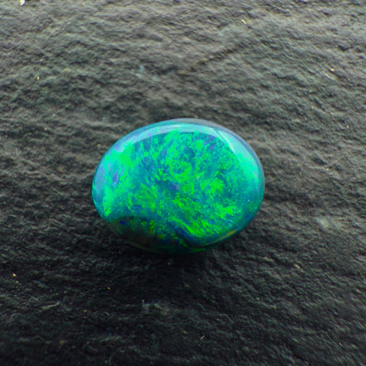 0.65cts Gem Black Opal With A Deep Green Blue Swirly Pattern
