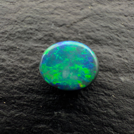 0.65cts Gem Black Opal With A Mixed Deep Green Blue Gold Pattern