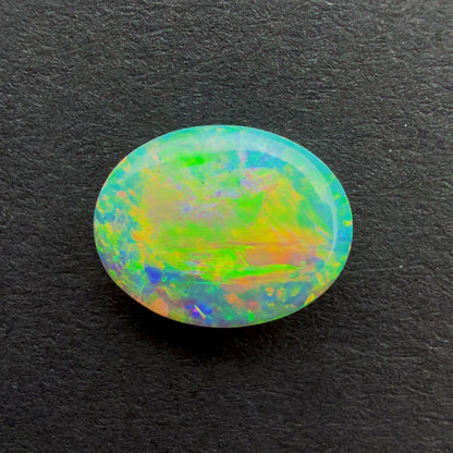 0.75cts Crystal Opal With A Green Yellow Gold Play Of Color, From Lightning Ridge Australia