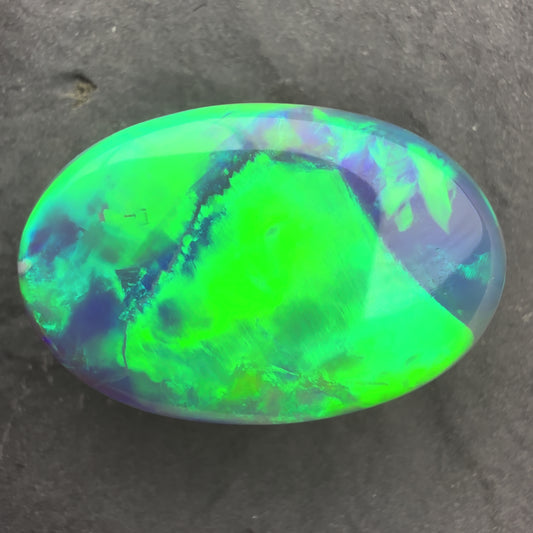 6.64ct World Class Black opal With Brilliant Green-Gold Color play And A Rolling Broad Flash Pattern
