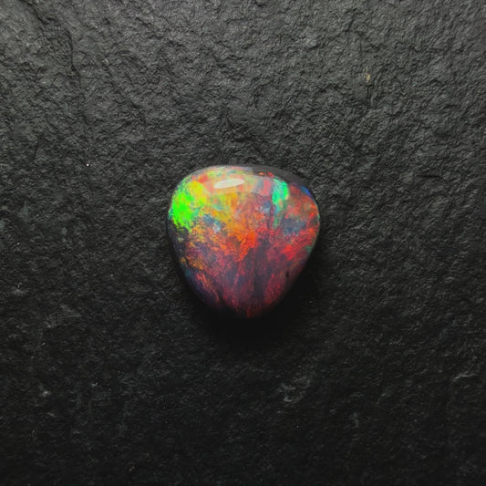 0.64ct Gem Black Opal With A Lovely Red Multi-Color Palette And Small Flash Pattern