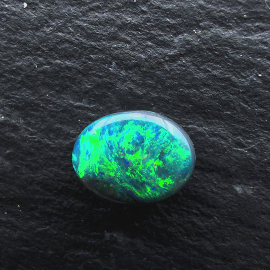 0.65cts Gem Black Opal With A Deep Green Blue Swirly Pattern