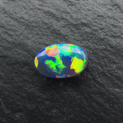 0.64ct World Class black opal With a Vivid Multicolor Palette and A Blocky Pattern