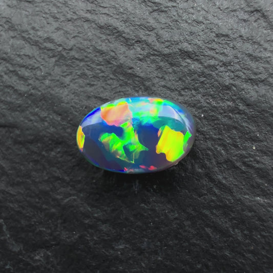0.64ct World Class black opal With a Vivid Multicolor Palette and A Blocky Pattern