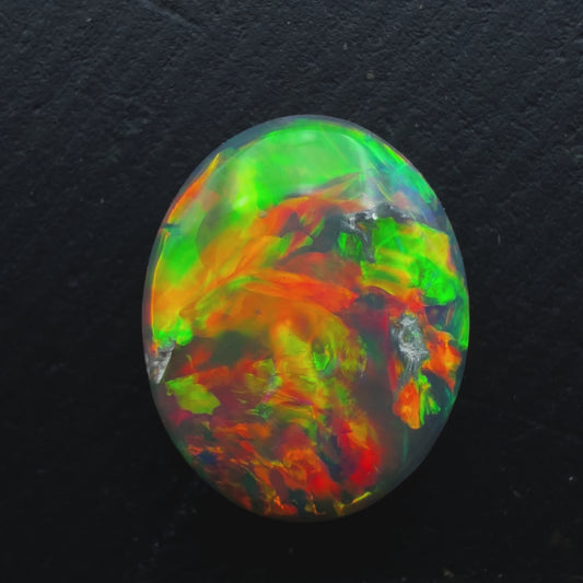 1.3ct Black Opal, With A vivid Orange Gold Color Palette And full faced Color