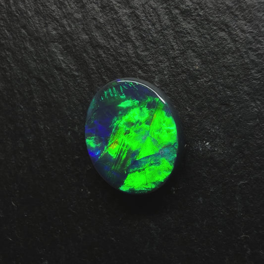 2.5ct Top Gem Black Opal With Avivid Dark Green Color Palette, Hints Of Blue And A Broad-flash Pattern