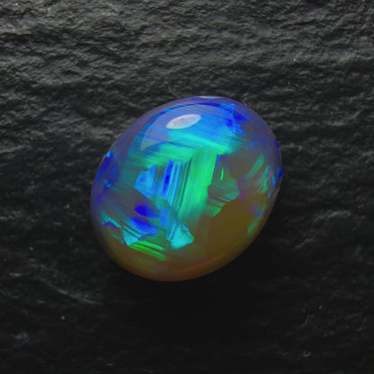 0.92ct Dark Crystal Opal, This Stone Has A Minty Green-Blue Color Pallet And A Mixed Paintbrush And chaff Pattern With Lots Of Depth