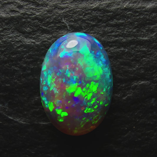 0.64ct Dark Crystal Opal With A Bright Blue Green Speckled Pinfire Like Pattern