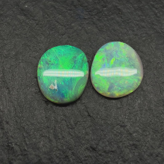 A Mismatched Pair Of Dark Opals With Moss patterns And A Minty Green Color Palette