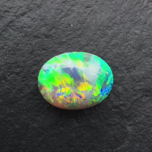 1.62ct Gem Dark Opal With Vivid Green-Gold Color Play And A Unique Striated Pattern