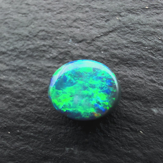 0.65cts Gem Black Opal With A Mixed Deep Green Blue Gold Pattern