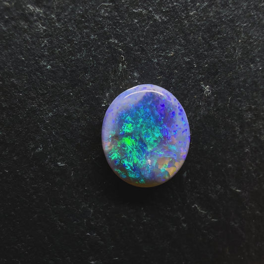 Mysterious Black Crystal Opal With A Central Blue-Green Pattern Fading To Violette At The Edges