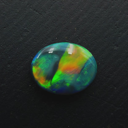 0.63 Black Opal With A Vivid Green-Orange Color Palette And Rare Ribbon Pattern
