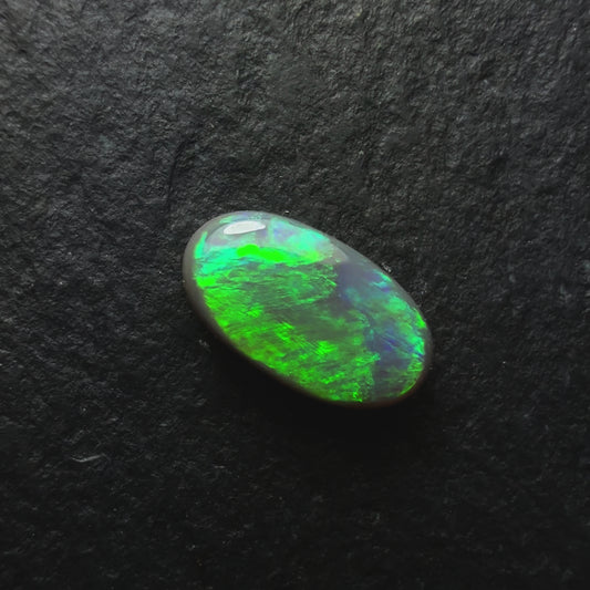 0.77ct Dark Opal, This Gem Has A Green-Gold Color Palette With A Textured Broadflash Pattern