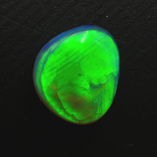 1.3ct Black Crystal Opal With A Brilliant Green Rolling Broadflash Pattern With Undertones Of Blue