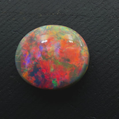 3.5ct Black Opal With A Rare Pink-Orange Broadflash Pattern, Shifting to Green As The Stone Is Moved