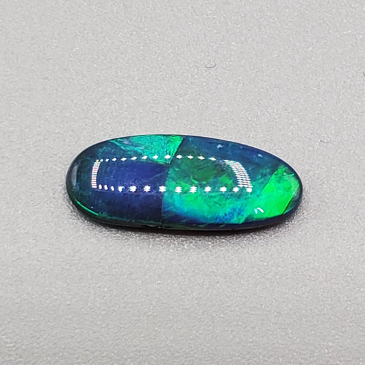 1.5cts Black opal with rolling flash and attractive color segmentation.