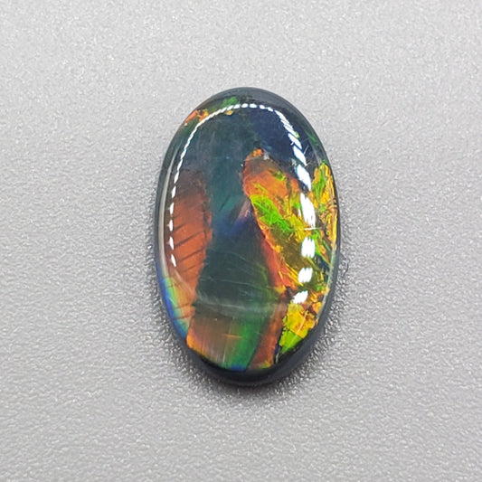 1.65cts Black opal with an iridescent ribbon pattern.