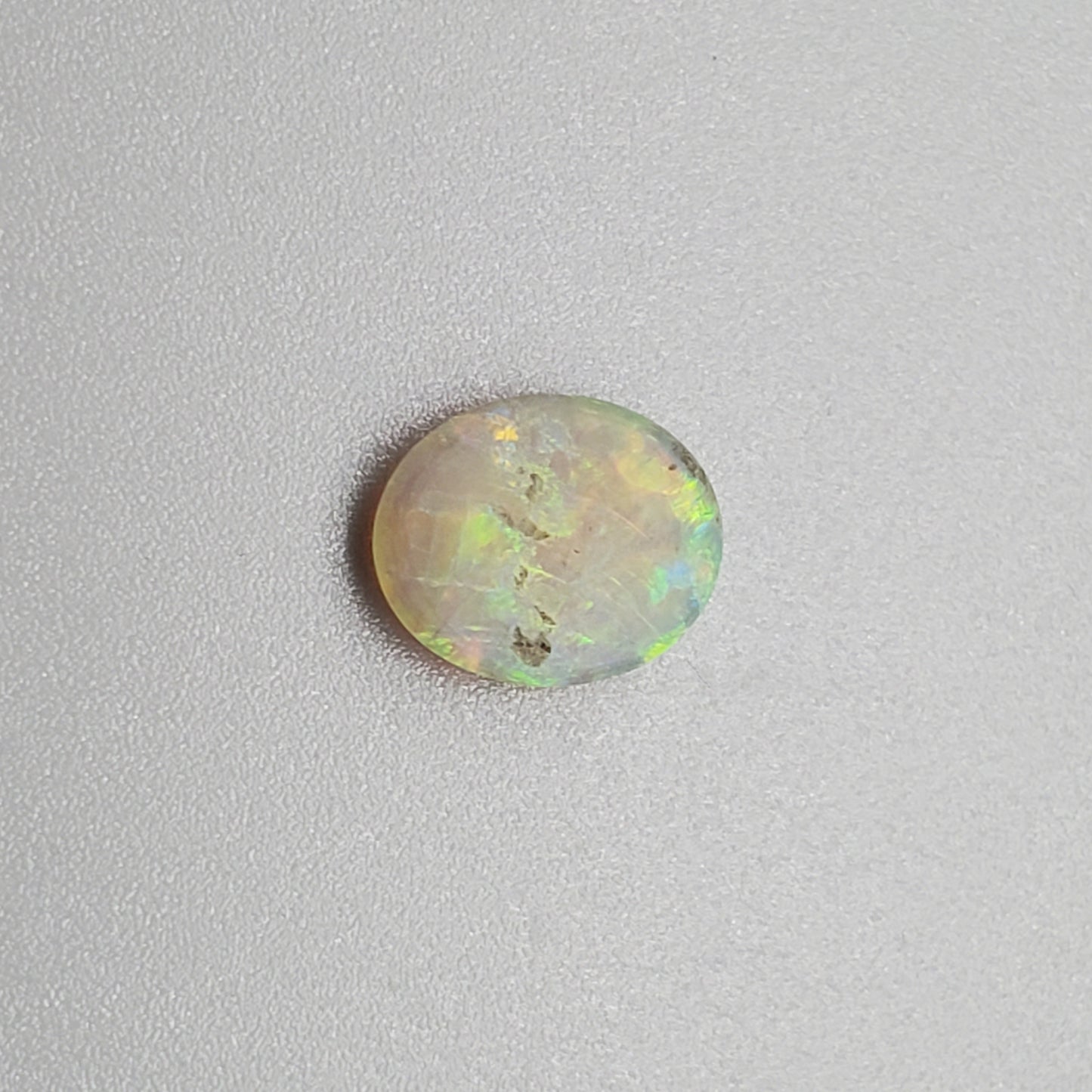 1.0ct Dark opal with Orange Green color play and a well-dispersed pattern