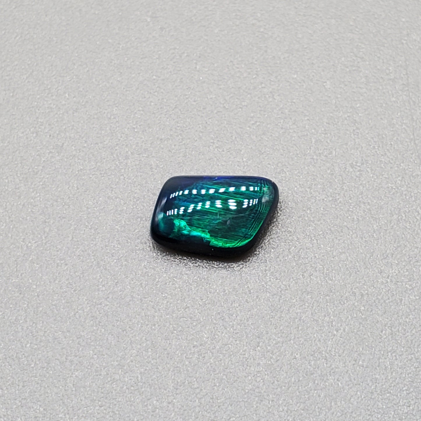 0.50cts Black Opal with iridescent Teal flash and broad rolling flash pattern