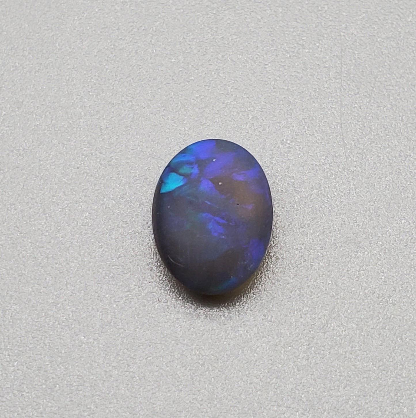 1.5cts Matte black crystal opal with subtle but rich blue green color play