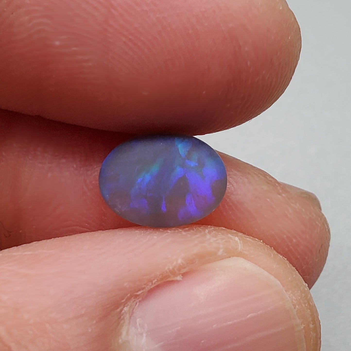 1.5cts Matte black crystal opal with subtle but rich blue green color play