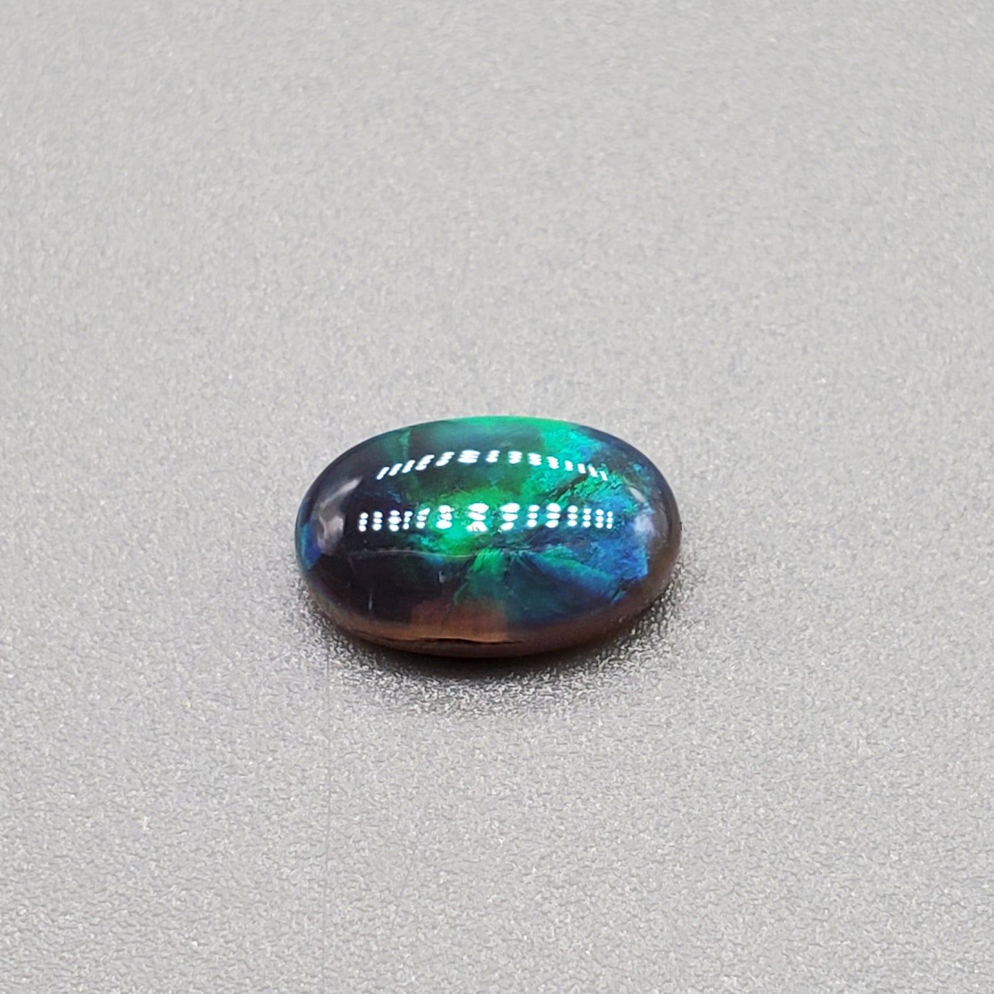 1.3cts Black Opal with Teal-blue rolling flash