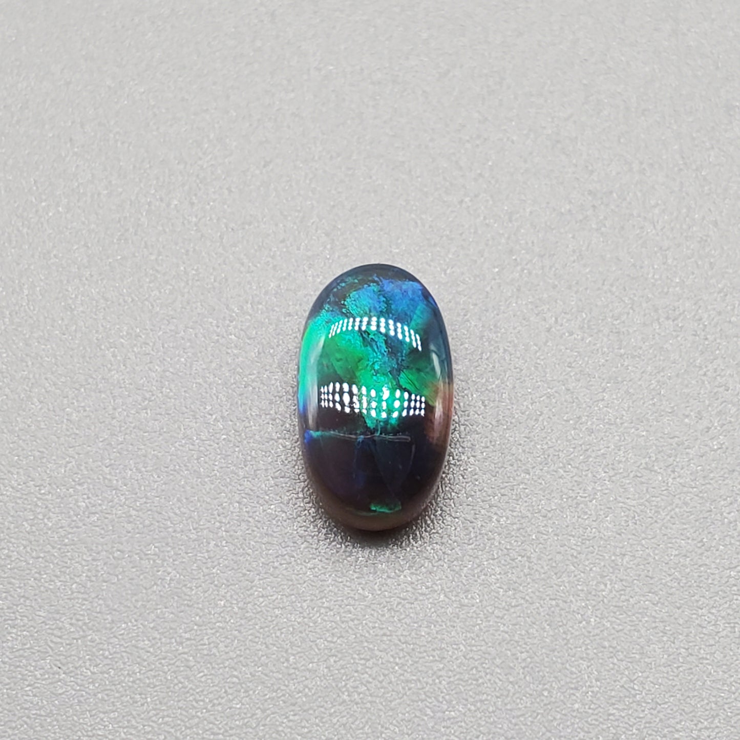 1.3cts Black Opal with Teal-blue rolling flash