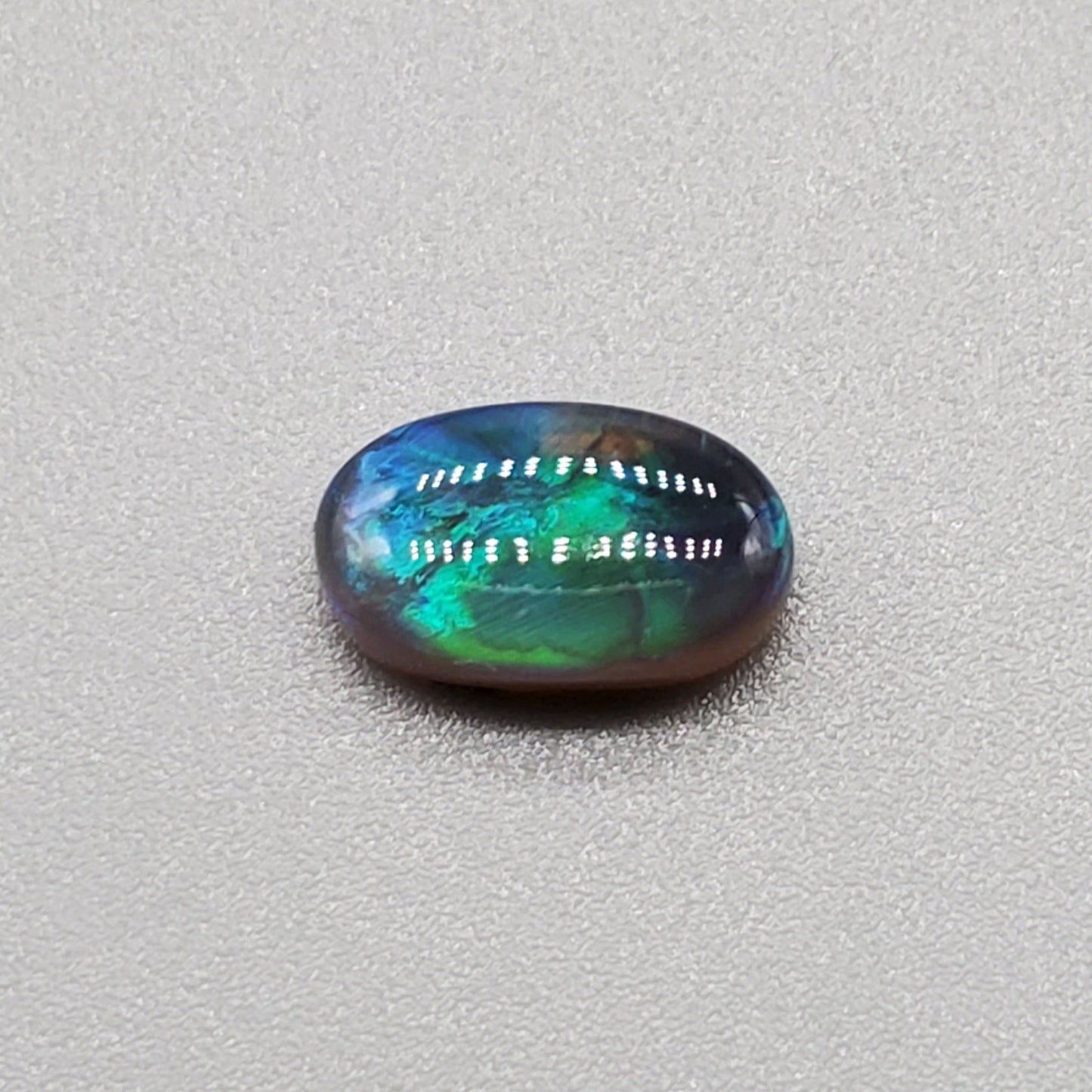 1.3cts Black Opal with Teal-blue rolling flash