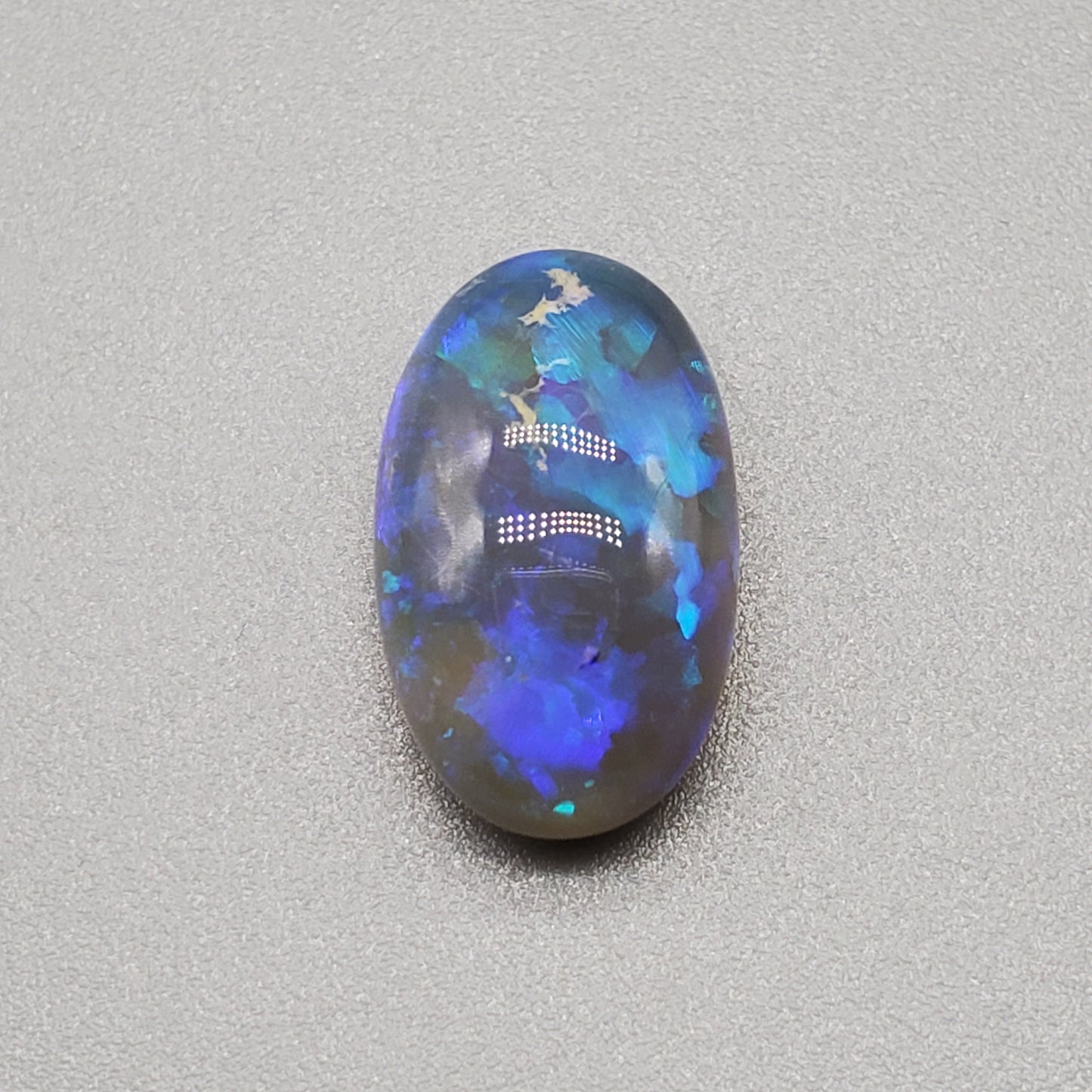 5.8cts Dark Crystal Opal with mixed blue color play large well dispersed patterning.