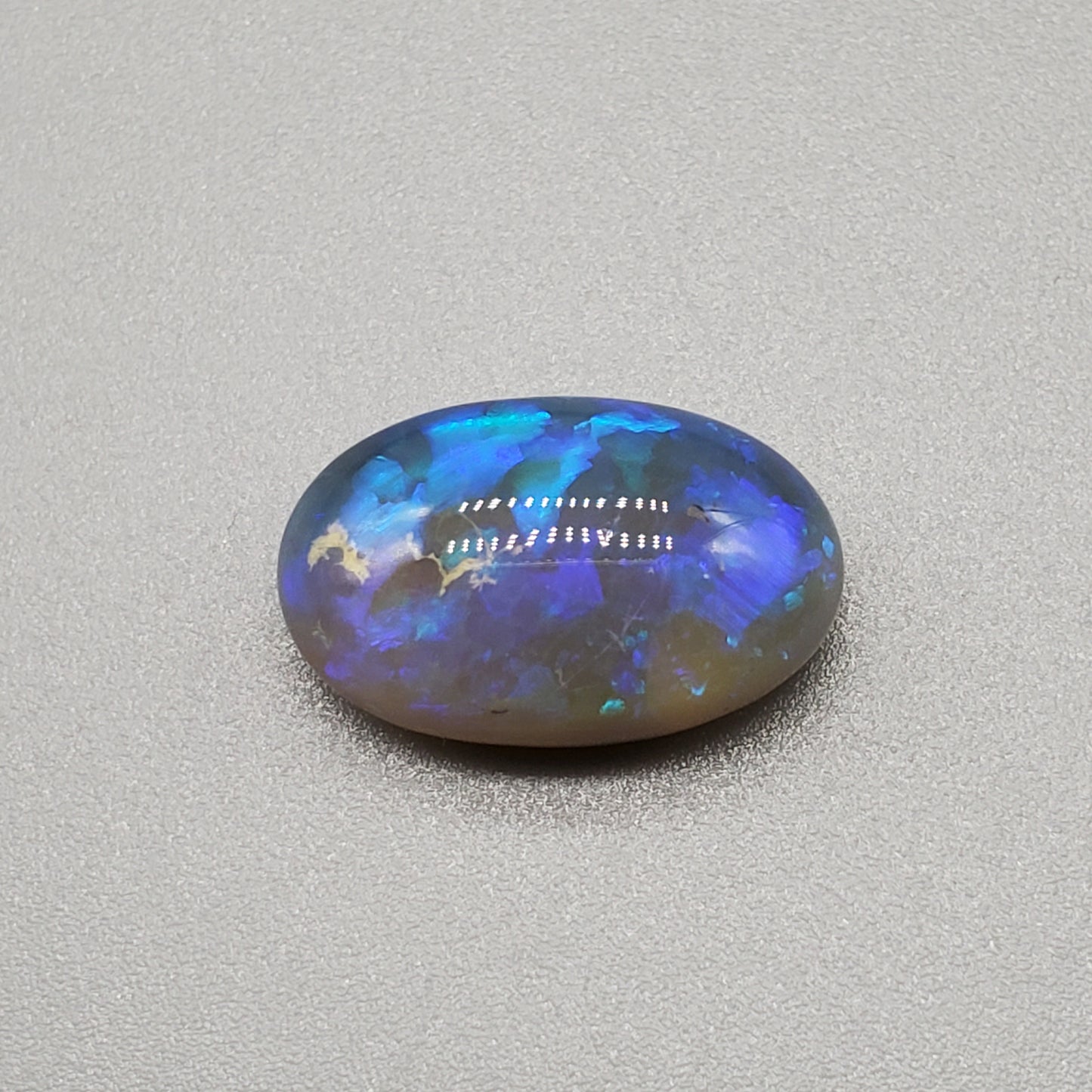 5.8cts Dark Crystal Opal with mixed blue color play large well dispersed patterning.