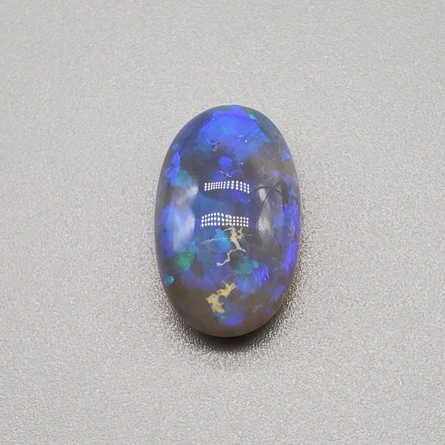 5.8cts Dark Crystal Opal with mixed blue color play large well dispersed patterning.