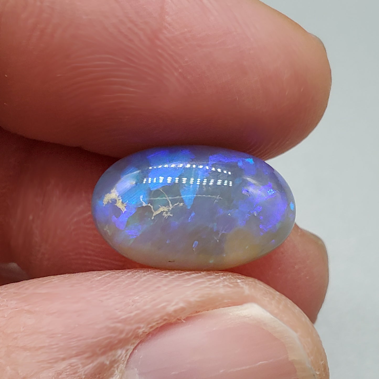 5.8cts Dark Crystal Opal with mixed blue color play large well dispersed patterning.